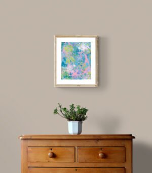 tropical daydream matted and framed hung above plant on wooden drawers